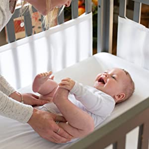 Airwrap Mesh Cot liner baby lying in cot with mothers arms reaching down